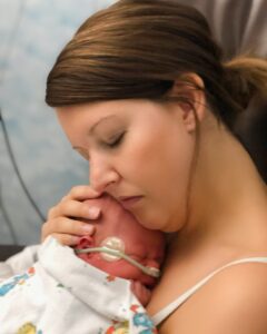 Natalee holds her baby in the NICU