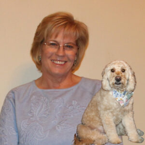 Headshot of Lori Good with dog Sadie